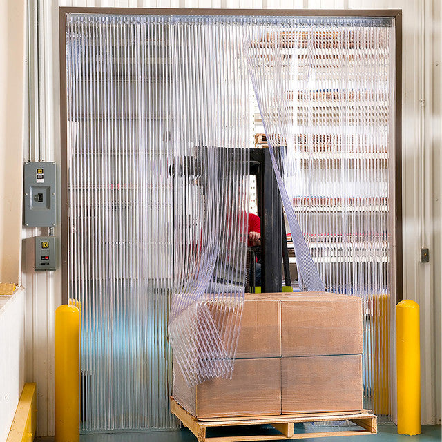 XPS Tech heavy-duty clear PVC strip curtain at a loading dock with forklift — 12 in × 0.120 in × 200 ft roll
