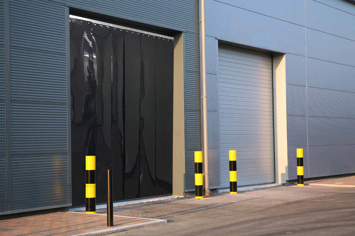 XPS Tech heavy-duty clear PVC strip curtain on an industrial door — 12 in × 0.120 in × 200 ft roll