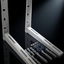 Two white metal wall mounting brackets with included wall anchors and screws, displayed on a reflective black background.