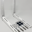 Two white metal mounting brackets with included wall anchors, screws, washers, and nuts on a light gray background.